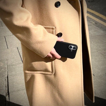 Person holding a Black Silicone iPhone 16 case
