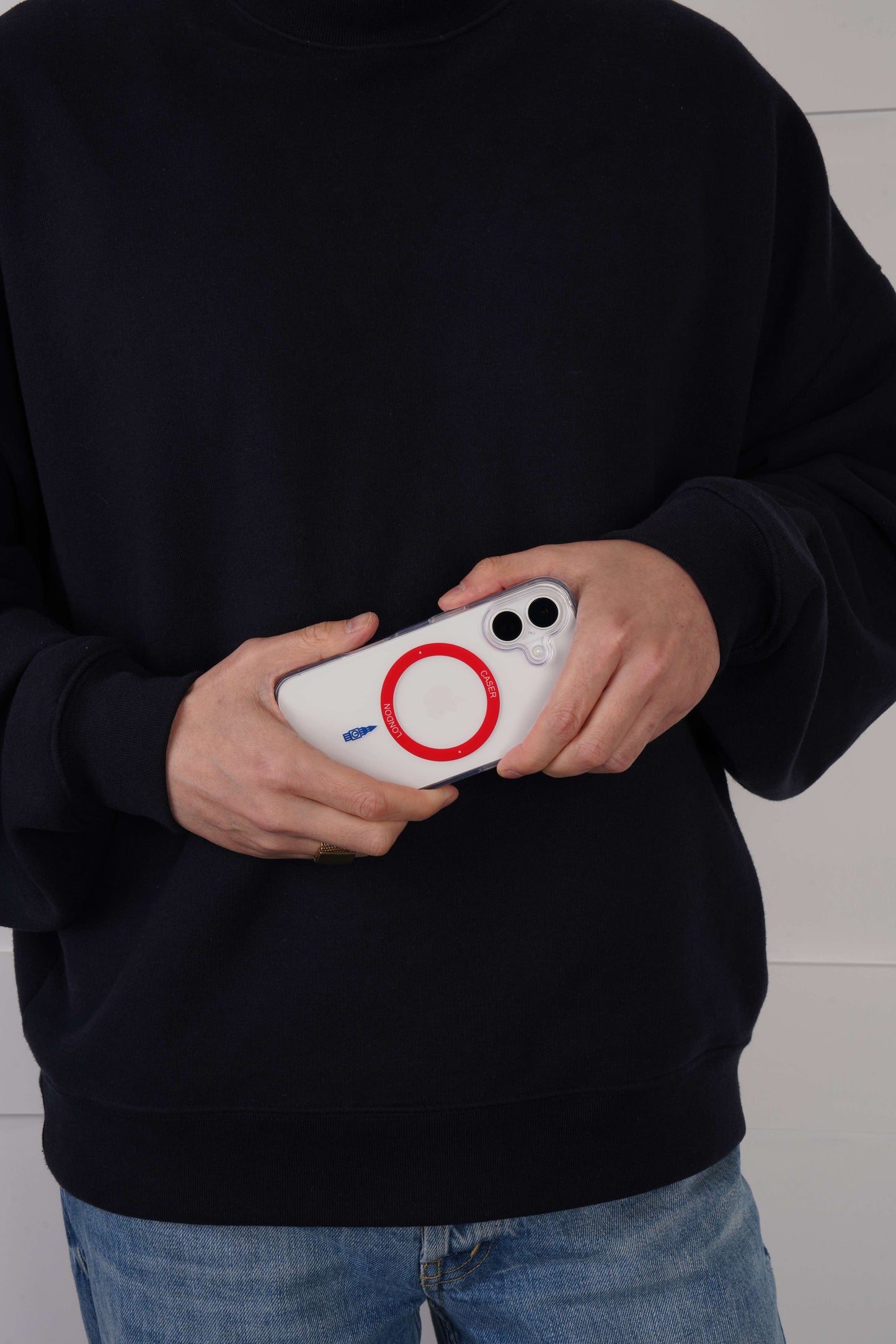 Person holding a iPhone 16 case with Red MagSafe Ring and Big Ben icon