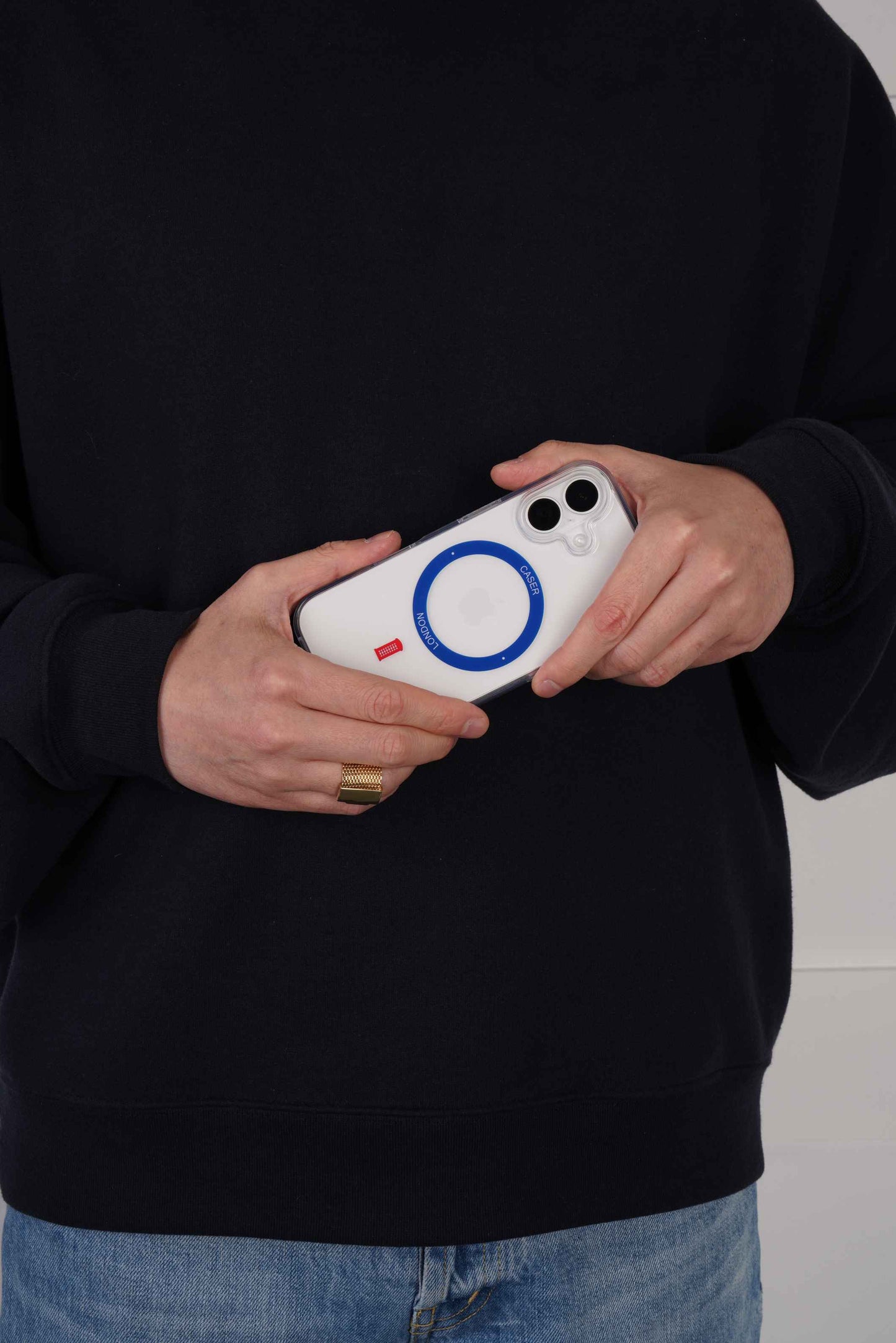 Person holding a iPhone 16 case with Royal Blue MagSafe Ring and Telephone Box icon