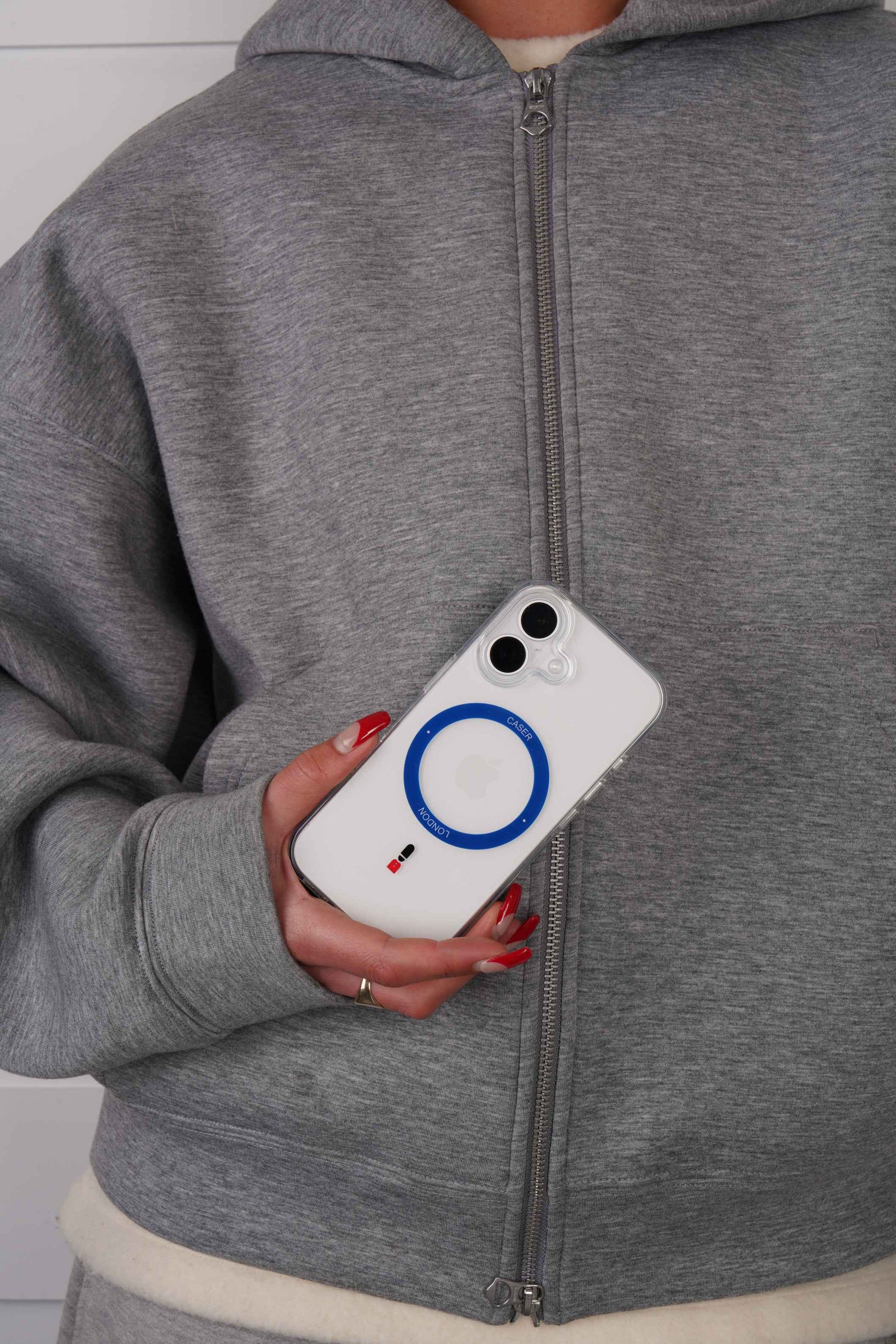 Person holding a iPhone 16 case with Royal Blue MagSafe Ring and Guard icon